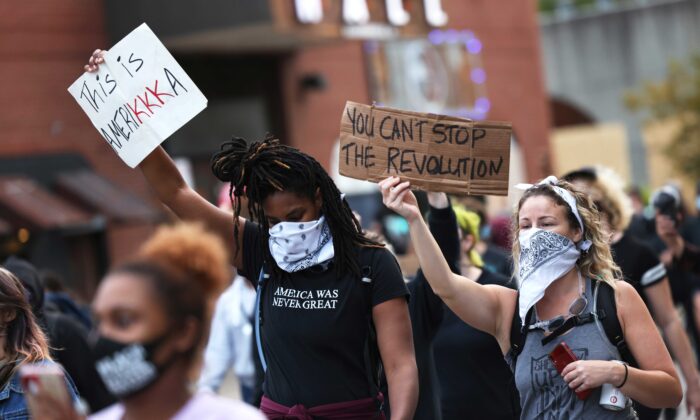 Người biểu tình cầm các biểu ngữ tuần hành ở Louisville, Ky., ngày 24/9/2020. (Ảnh Michael M. Santiago/Getty Images)