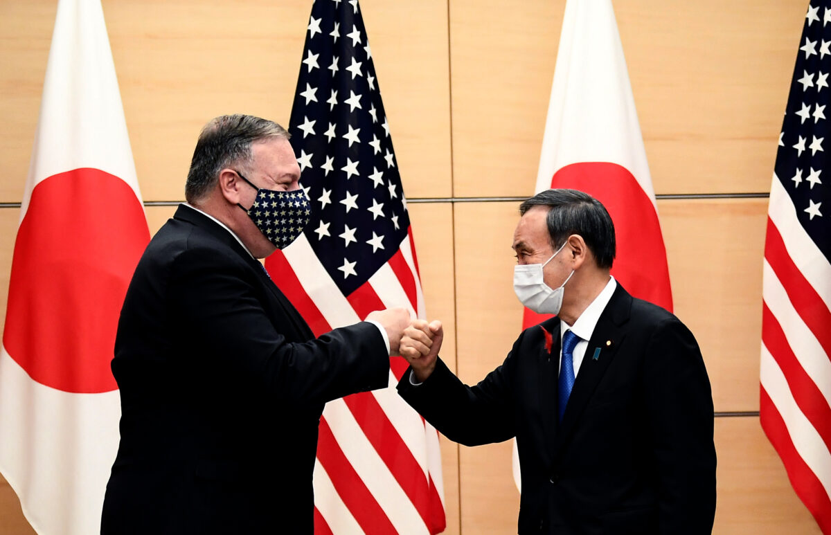 Thủ tướng Nhật Bản Yoshihide Suga (phải) và Ngoại trưởng Mỹ Mike Pompeo (trái) nắm tay nhau khi họ gặp nhau tại văn phòng thủ tướng ở Tokyo vào ngày 6/10/2020. (Ảnh Charly Triballeau/ POOL/ AFP qua Getty Images)