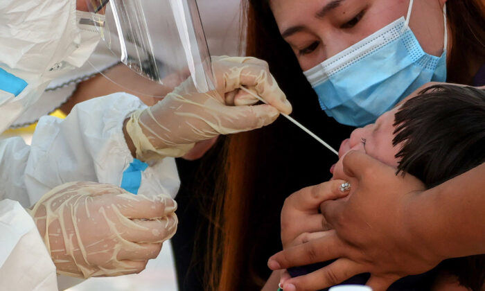 Một đứa trẻ được xét nghiệm acid nucleic để phát hiện COVID-19 ở Trịnh Châu, thuộc tỉnh Hà Nam, miền trung Trung Quốc vào ngày 31/07/2021. (Ảnh: AFP qua Getty Images)