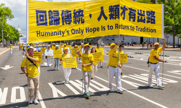 Các học viên Pháp Luân Công tham gia một lễ diễn hành kỷ niệm 20 năm cuộc đàn áp Pháp Luân Công ở Trung Quốc, tại Hoa Thịnh Đốn vào ngày 18/07/2019. (Ảnh: Mark Zou/The Epoch Times)