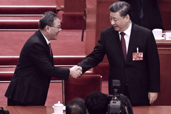 Lãnh đạo Trung Quốc Tập Cận Bình (phải) được người nắm quyền lực thứ hai là ông Lý Cường chúc mừng sau khi được xác nhận là Chủ tịch nước nhiệm kỳ thứ ba trong phiên họp toàn thể lần thứ ba của Đại hội đại biểu Nhân dân Toàn quốc tại Bắc Kinh hôm 10/03/2023. (Ảnh: Noel Celis/AFP qua Getty Images)