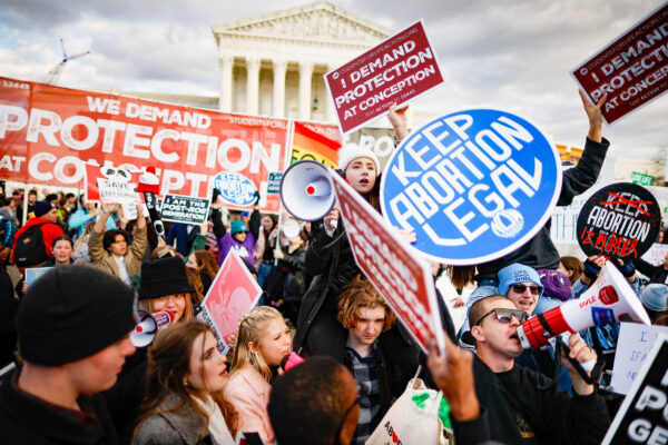 Các nhà hoạt động ủng hộ sự sống và ủng hộ phá thai giương cao các biểu ngữ có quan điểm đối lập trong cuộc tập hợp March for Life thường niên lần thứ 50 trước Tối cao Pháp viện Hoa Kỳ ở Hoa Thịnh Đốn, hôm 20/01/2023. (Ảnh: Chip Somodevilla/Getty Images)