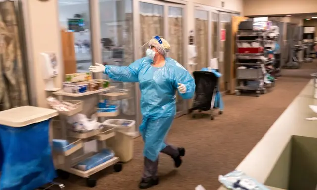 Một y tá tại Trung tâm Y tế Three Rivers Asante chạy đến một phòng trong Khu Chăm sóc Đặc biệt để giúp nhân viên y tế điều trị cho một bệnh nhân COVID-19 ở Grants Pass, Oregon, vào ngày 09/09/2021. (Ảnh: Nathan Howard/Getty Images)