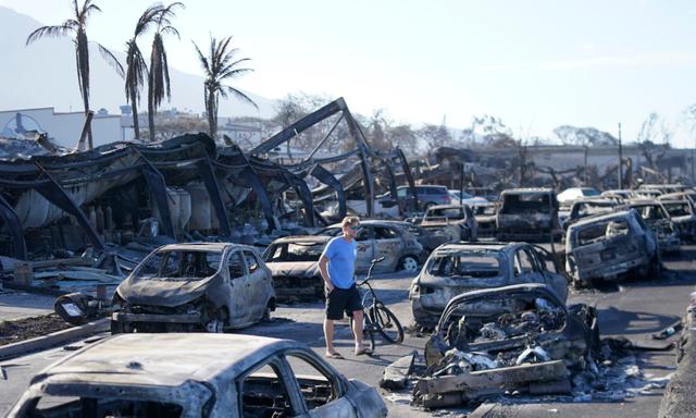 Một người đi qua đống đổ nát do cháy rừng ở Lahaina, Hawaii, hôm 11/08/2023. (Ảnh AP/Rick Bowmer)