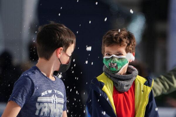 Trẻ em đeo khẩu trang bảo hộ ném tuyết vào nhau khi trượt băng tại Công viên Bryant trong đại dịch do virus corona (COVID-19) ở quận Manhattan của thành phố New York, vào ngày 14/01/2022. (Ảnh: Carlo Allegri/Reuters)