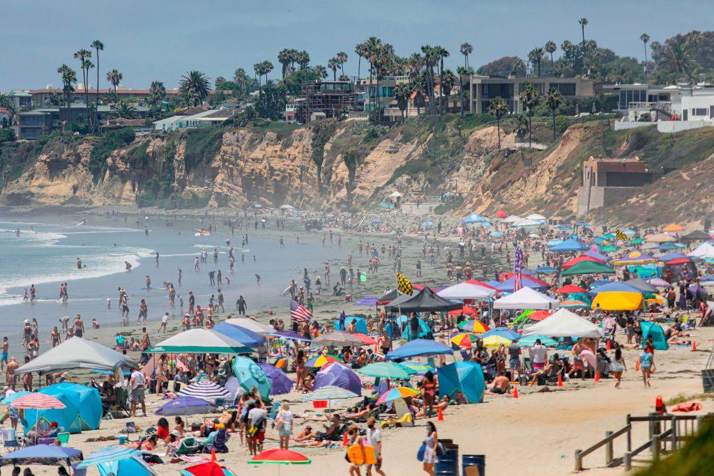 Những người đi chơi biển được nhìn thấy dọc theo bờ biển ở khu vực Bãi biển Thái Bình Dương của San Diego vào ngày 04/07/2020. (Ảnh: Sandy Huffaker/AFP qua Getty Images)