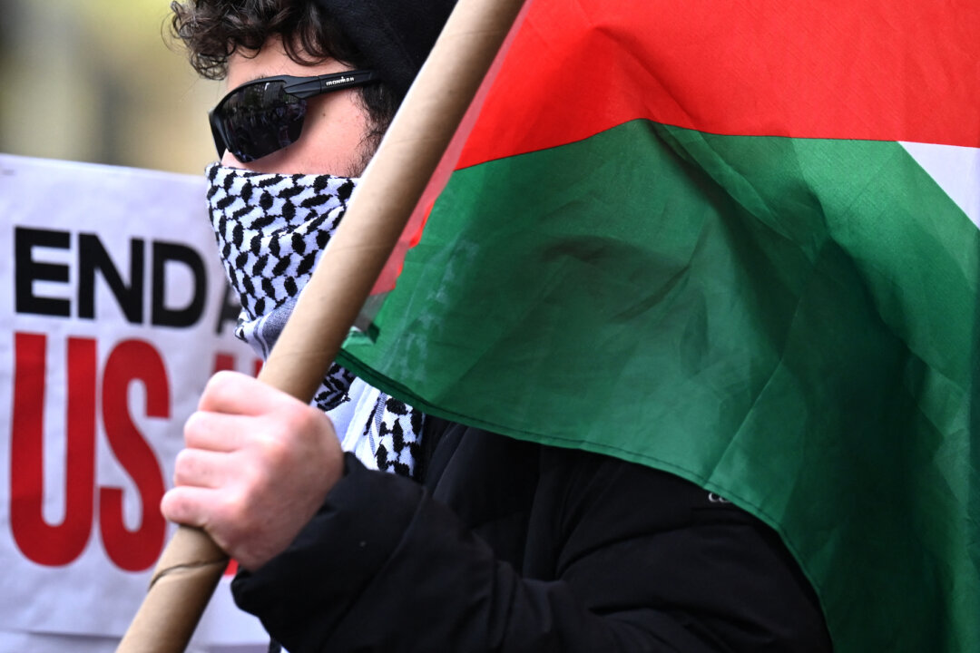 Một người biểu tình ủng hộ Palestine mang theo cờ Palestine bên ngoài khuôn viên trường Đại học Columbia ở thành phố New York, hôm 24/04/2024. (Ảnh: Timothy Clary/AFP)